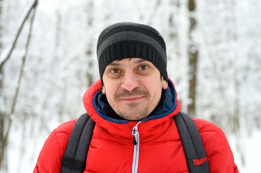 C4 client Corey hiking in a snowy forest